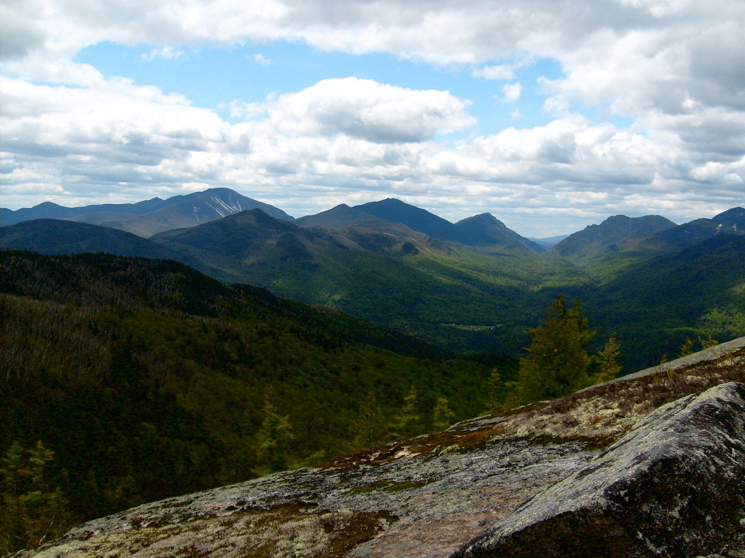 Adirondack High Peaks in spring with fresh greenery and clouds